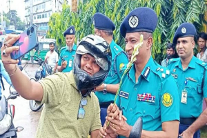হেলমেট পরা মোটরসাইকেল চালকদের পুলিশের ফুল
